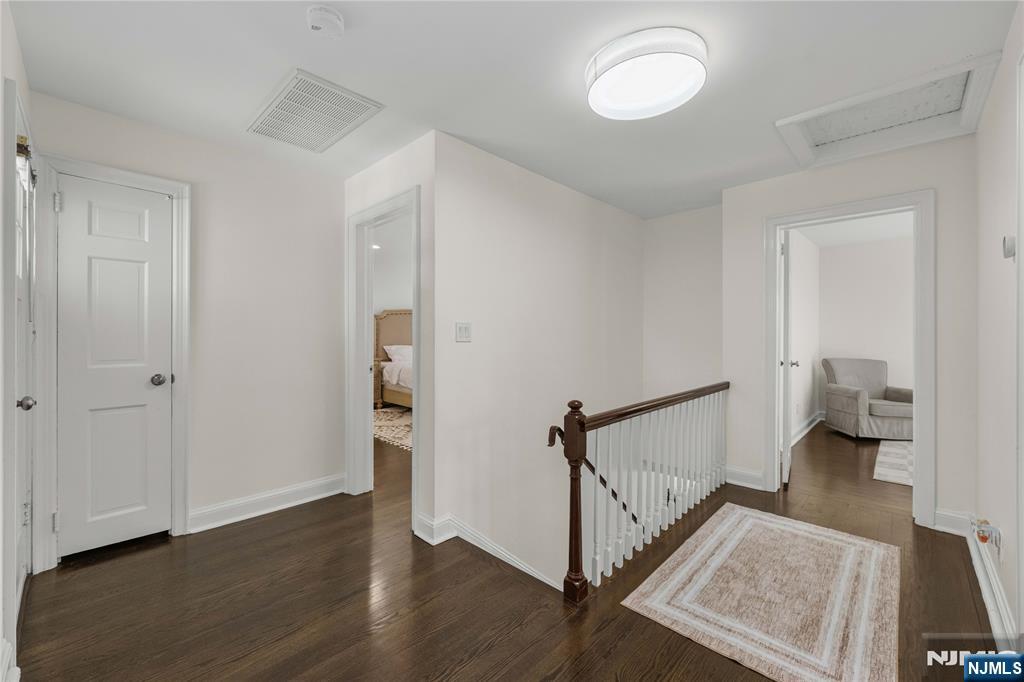 609 Wyndham Road Teaneck, NJ 07666 - Photo 5 of 26 a view of a room with wooden floor and staircase