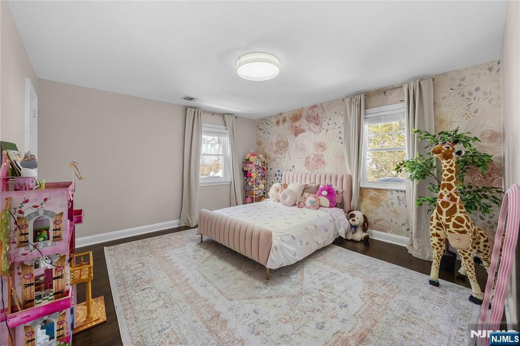 609 Wyndham Road Teaneck, NJ 07666 - Photo 8 of 26 a bedroom with a bed and a window