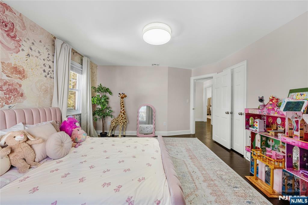 609 Wyndham Road Teaneck, NJ 07666 - Photo 9 of 26 a bedroom with bed and a book shelf