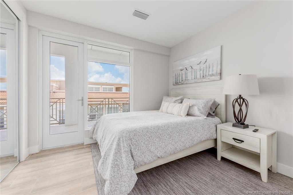 41 Southwest Seminole Street, Unit 410 Stuart, FL 34994 - Photo 22 of 54 a bedroom with a bed and a window