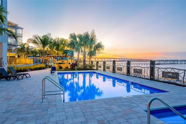 a swimming pool with outdoor seating and yard