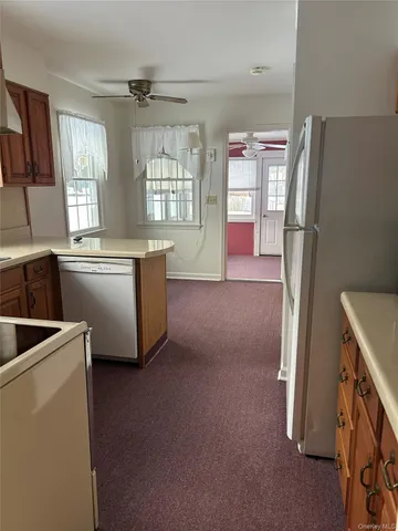 a kitchen with refrigerator and window