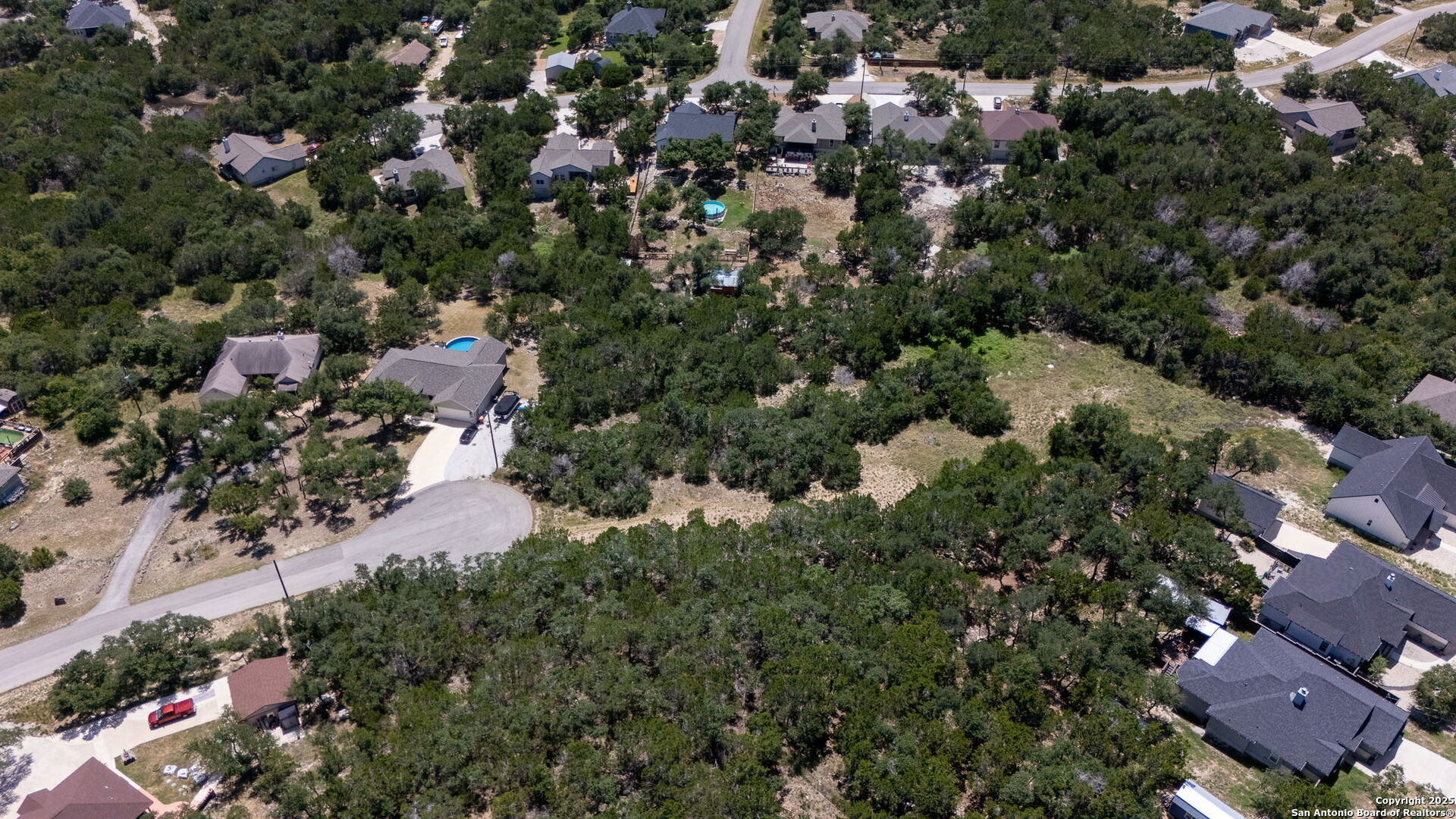 1465 Ironwood Road Fischer, TX 78623 - Photo 4 of 9 an aerial view of a house with a yard and lake view