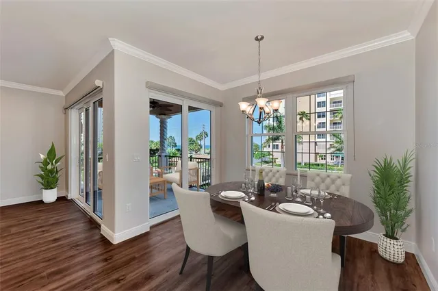 a living room with furniture kitchen view and a chandelier