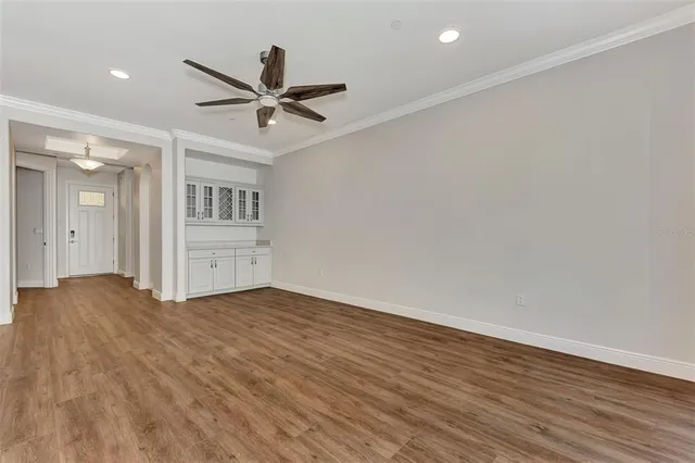 a view of an empty room with wooden floor