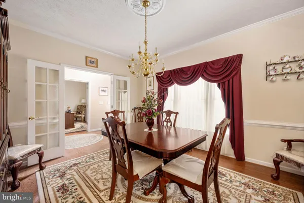 a living room with furniture chandelier and a fireplace