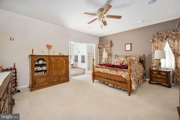 a spacious bathroom with a granite countertop tub sink and mirror