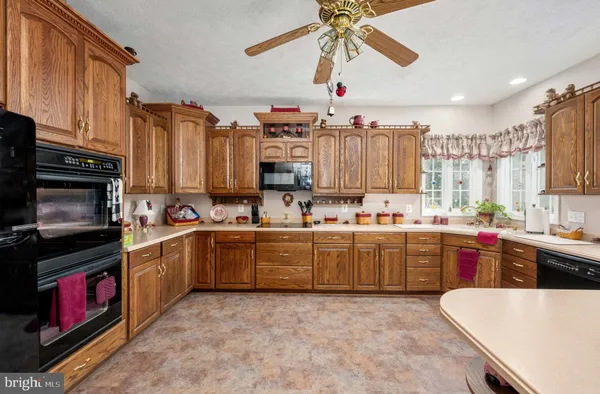 a dining room with furniture a chandelier and a rug