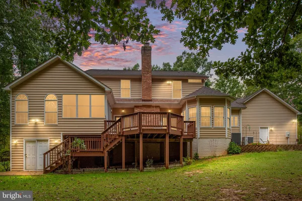 a front view of a house with a garden and yard