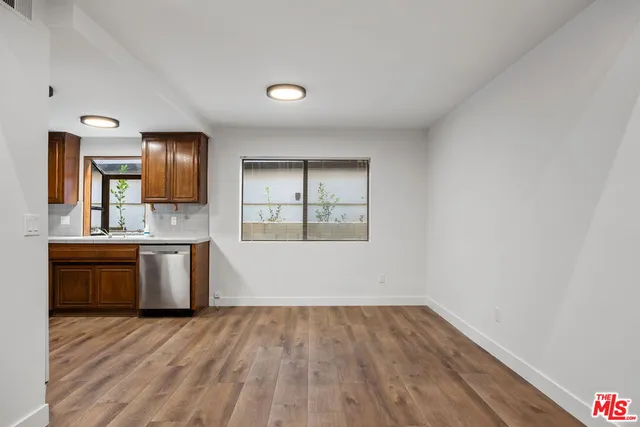 a view of a kitchen counter space and wooden floor