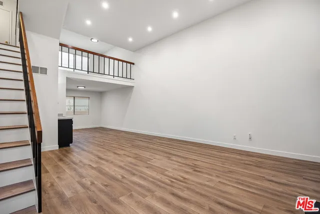 wooden floor in an empty room with a gallery