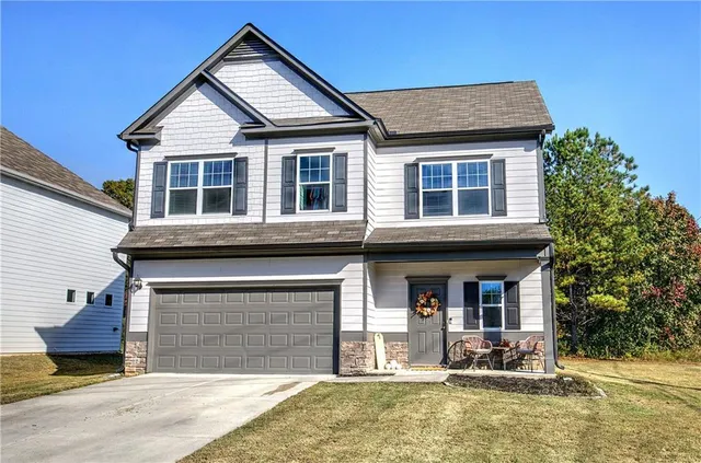 a front view of a house with a yard table and chairs
