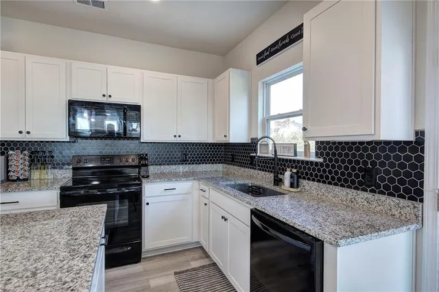 a kitchen with a sink stove and microwave