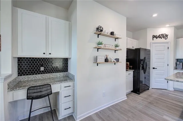 a kitchen with a refrigerator and cabinets