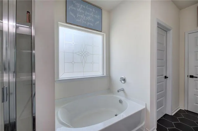a white bath tub sitting next to a window