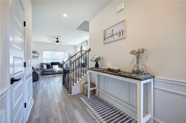 a view of entryway livingroom and hall with wooden floor