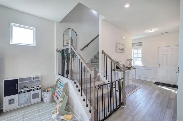 a view of entryway with wooden floor and windows