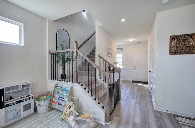 a view of a hallway with wooden floor and entryway