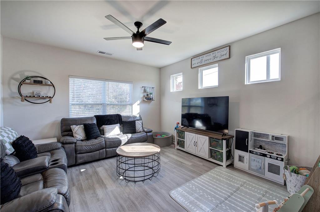 10 Eagle Drive Northwest Cartersville, GA 30121 - Photo 10 of 41 a living room with furniture a rug and a flat screen tv