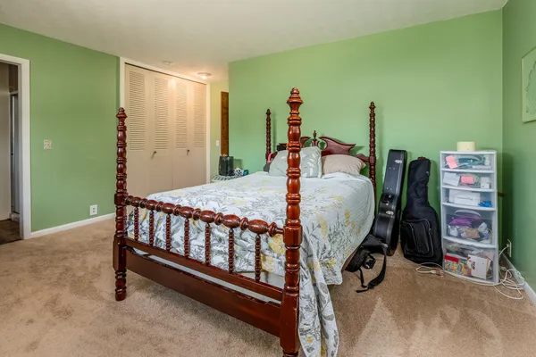 a bedroom with furniture and a wooden floor