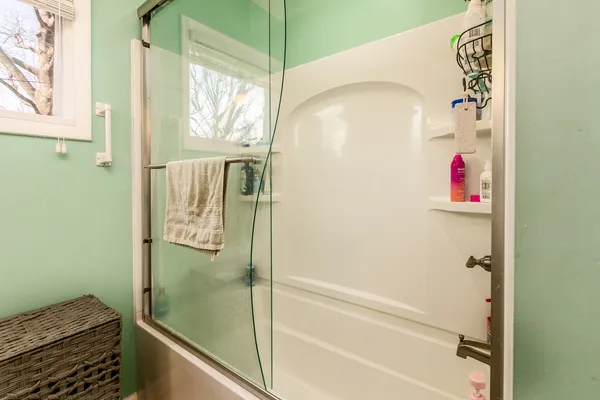 a bathroom with a bathtub and shower