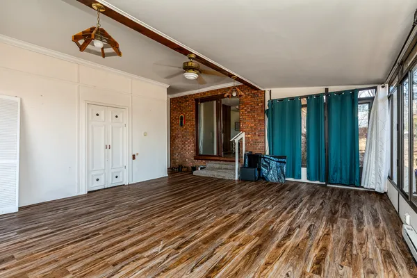 a view of a room with wooden floor and stairs