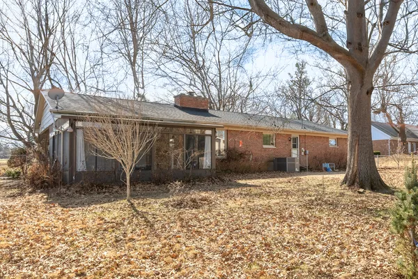 a view of a house with a yard covered in snow