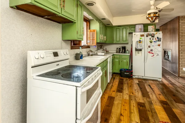 a kitchen that has a refrigerator and a sink
