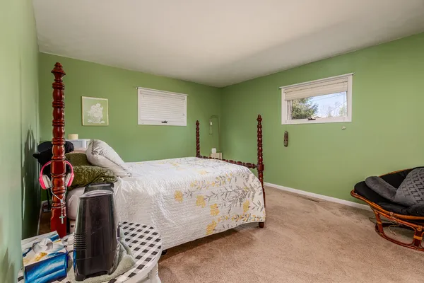 a bedroom with bed and a window