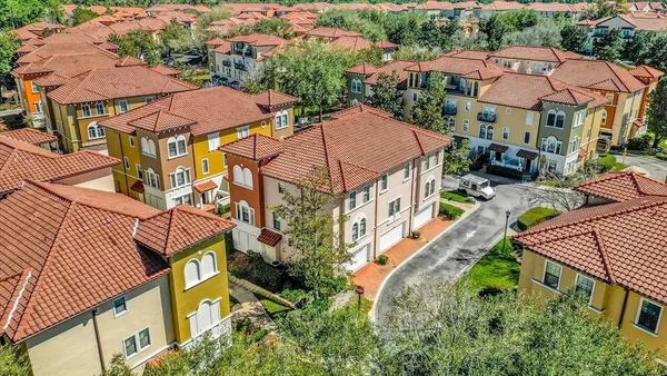 an aerial view of multiple houses with yard