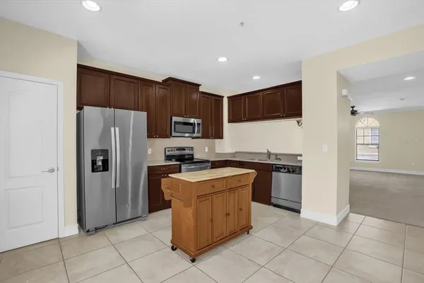 a kitchen with a sink a stove and cabinets