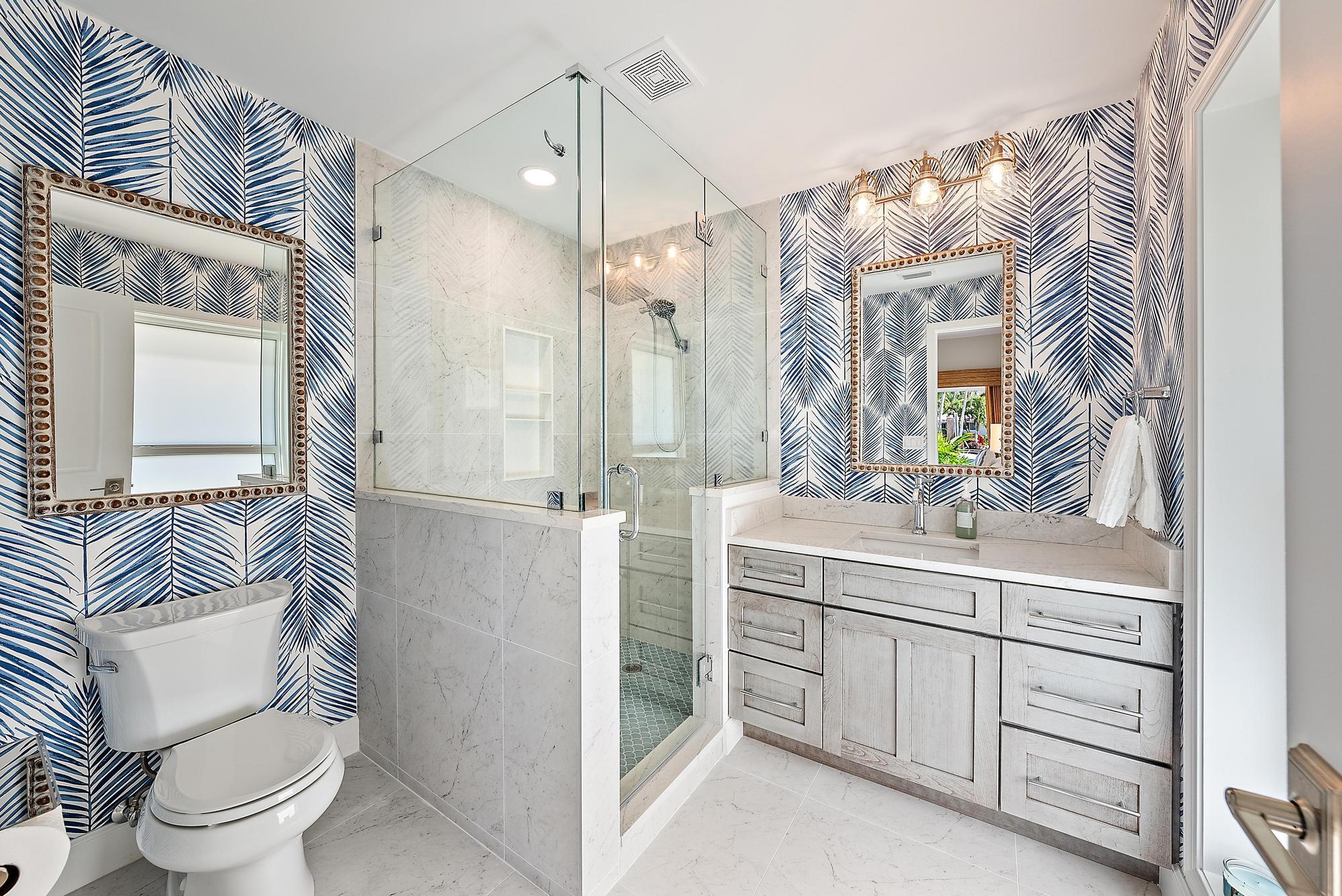 19 Island Road Sewall's Point, FL 34996 - Photo 27 of 50 a bathroom with a sink a toilet a mirror and shower