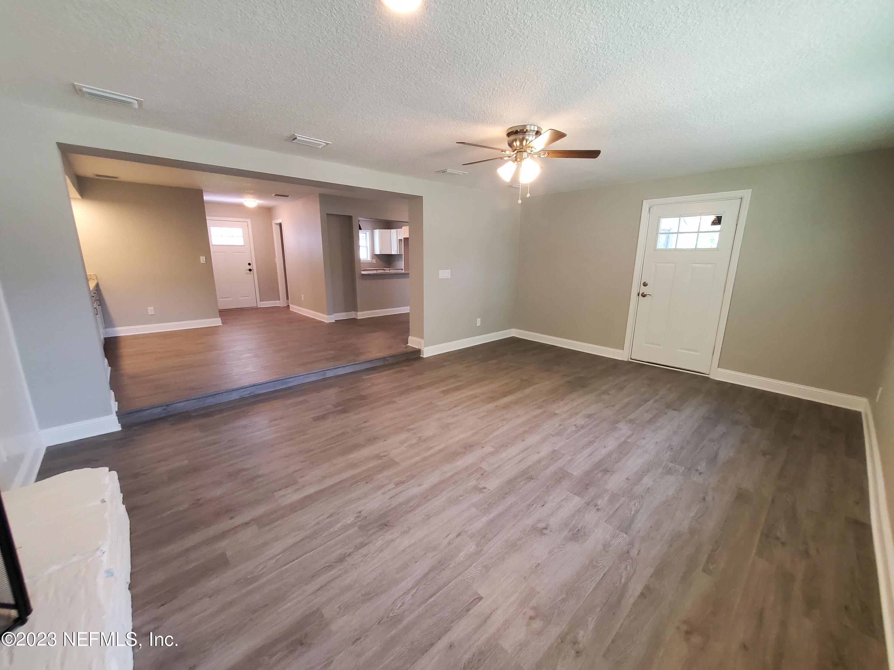 2305 Brest Road Jacksonville, FL 32216 - Photo 11 of 32 an empty room with wooden floor and windows