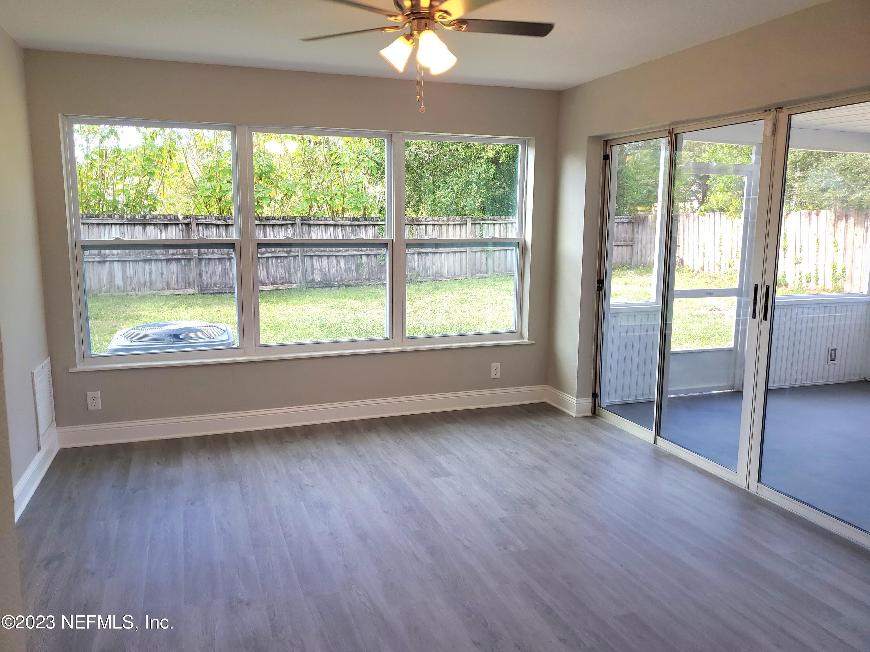 2305 Brest Road Jacksonville, FL 32216 - Photo 17 of 32 a view of an empty room with wooden floor and a window