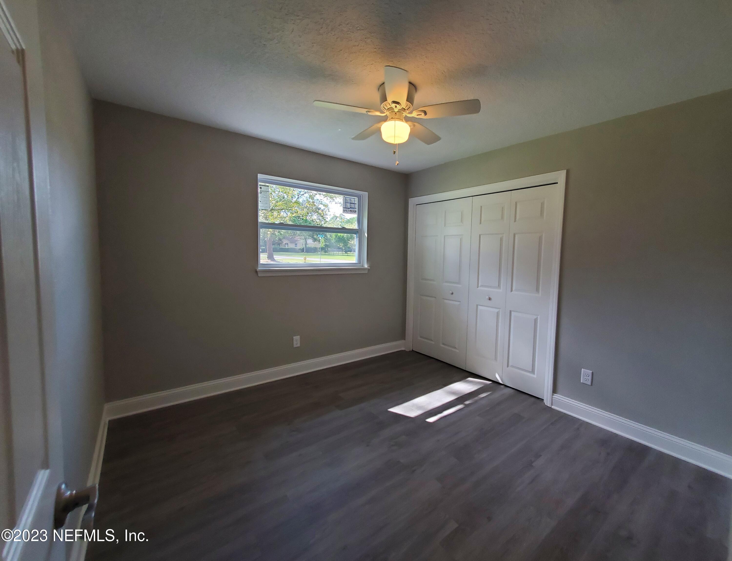 2305 Brest Road Jacksonville, FL 32216 - Photo 18 of 32 a view of an empty room with window and wooden floor