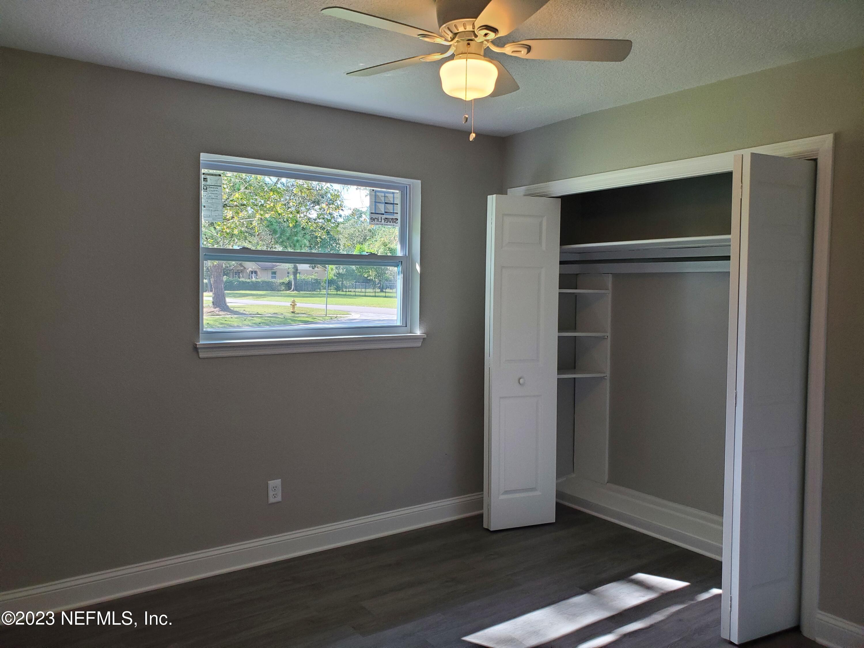 2305 Brest Road Jacksonville, FL 32216 - Photo 19 of 32 a view of an empty room with wooden floor and a window