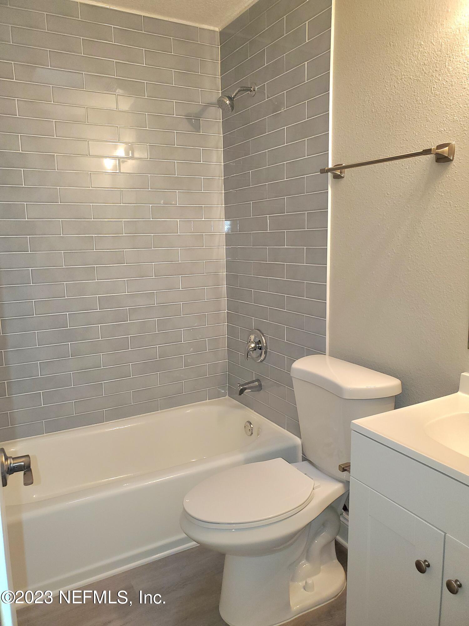 2305 Brest Road Jacksonville, FL 32216 - Photo 20 of 32 a white toilet sitting next to a bath tub and a shower