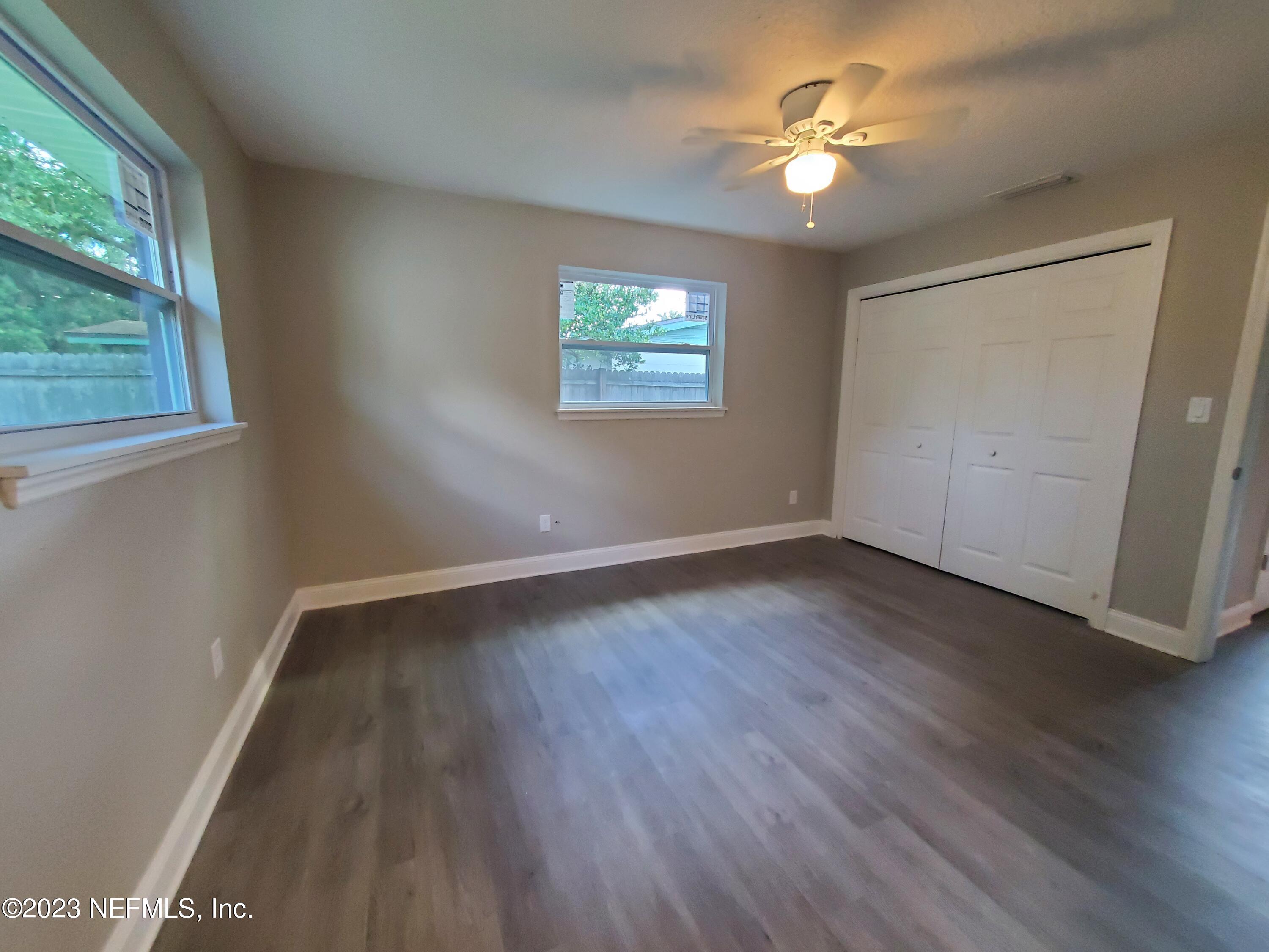 2305 Brest Road Jacksonville, FL 32216 - Photo 23 of 32 wooden floor in an empty room with a window