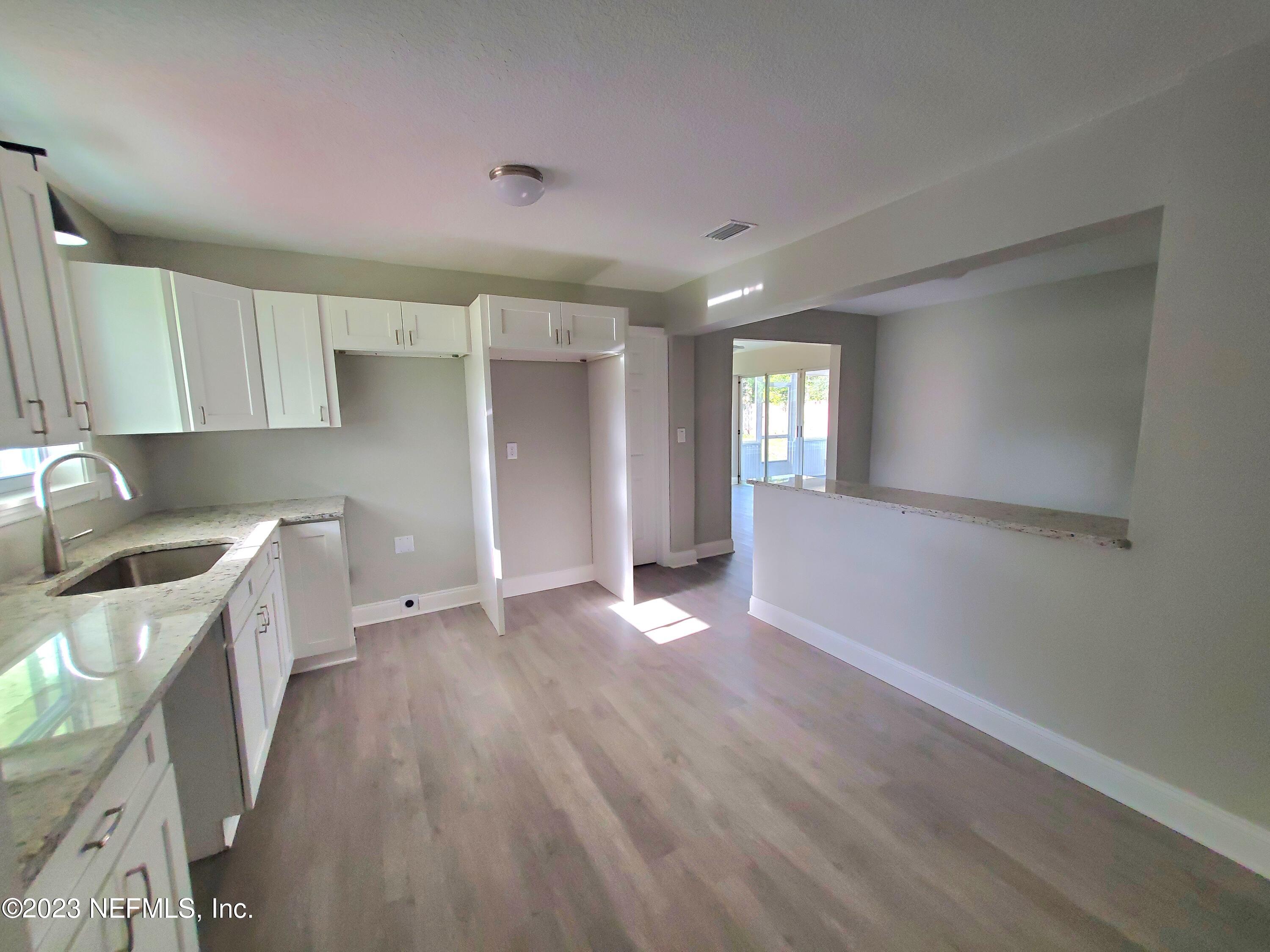 2305 Brest Road Jacksonville, FL 32216 - Photo 3 of 32 a view of a kitchen with a sink cabinets and wooden floor