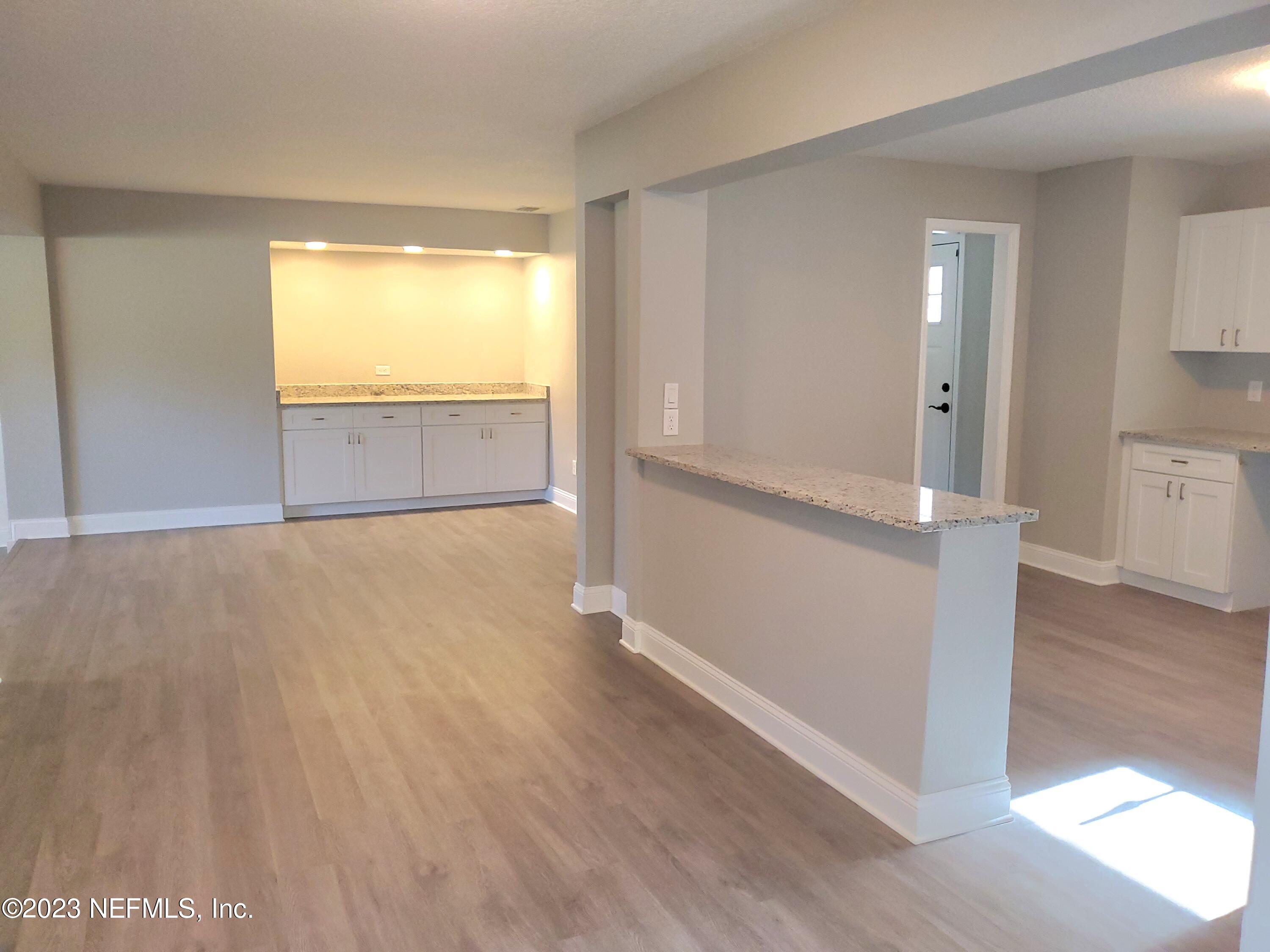 2305 Brest Road Jacksonville, FL 32216 - Photo 4 of 32 wooden floor in an empty room with a window