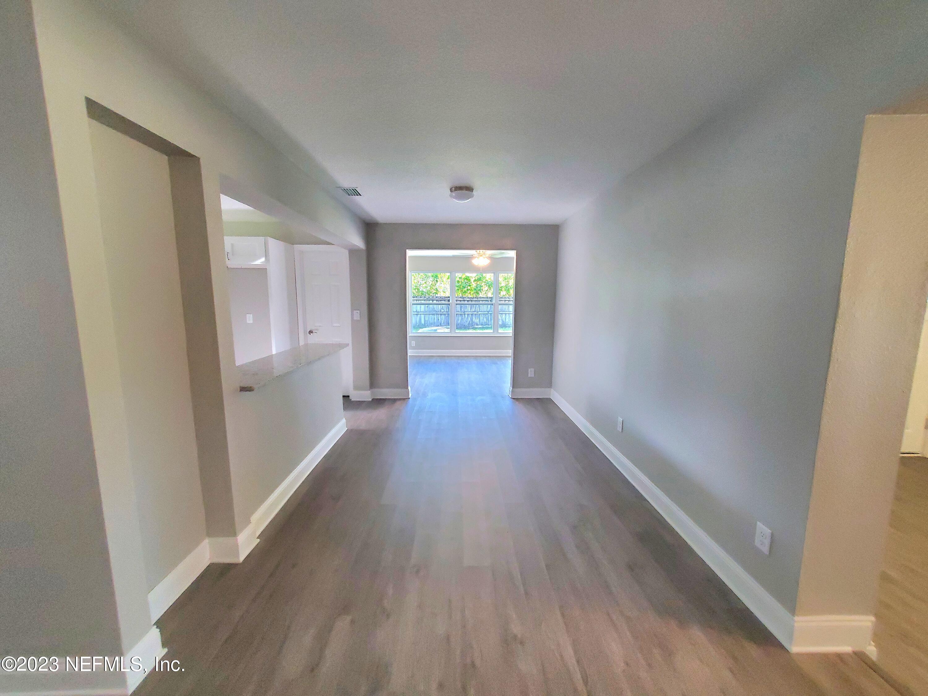 2305 Brest Road Jacksonville, FL 32216 - Photo 6 of 32 a view of a hallway with wooden floor