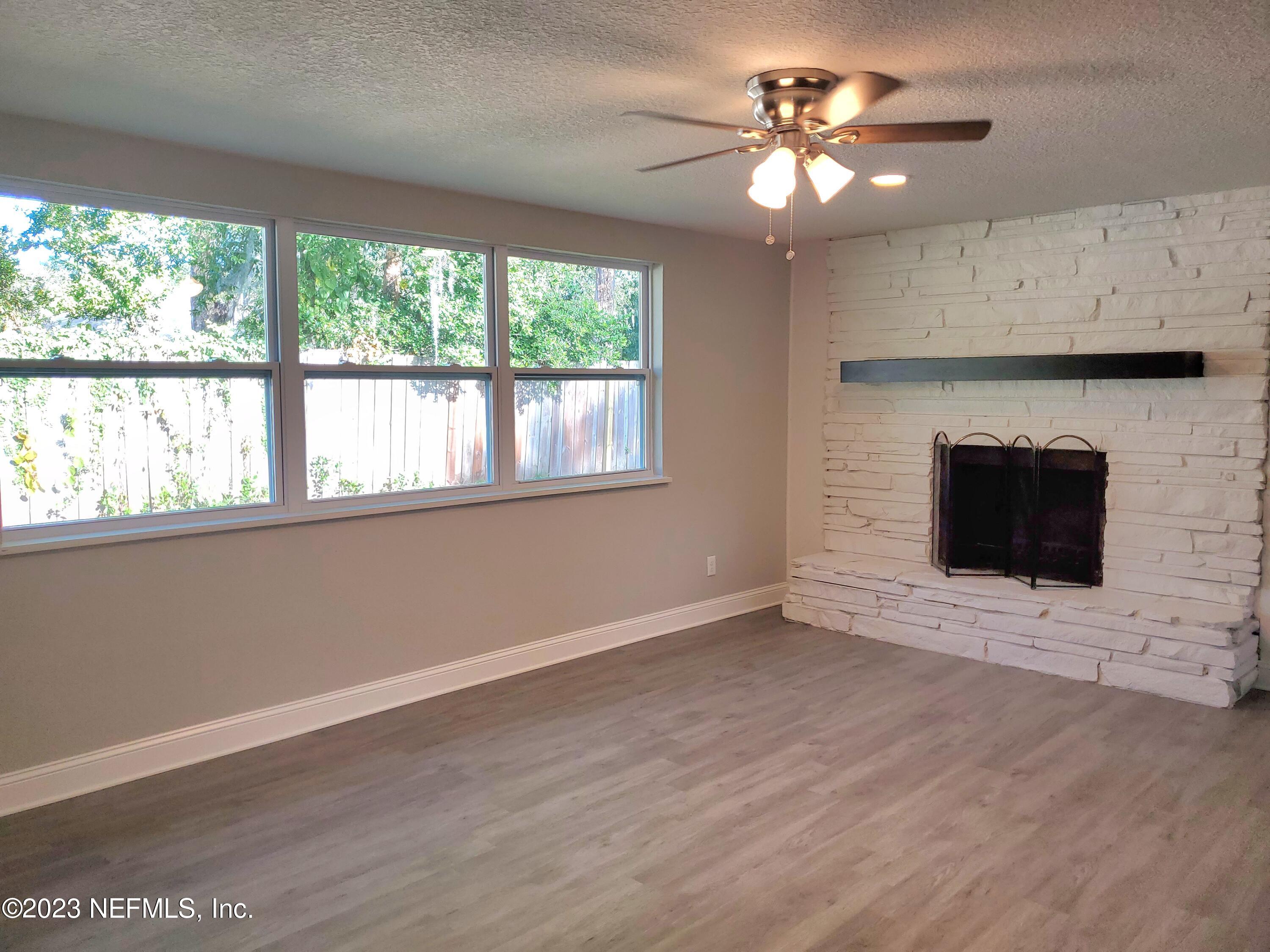 2305 Brest Road Jacksonville, FL 32216 - Photo 10 of 32 a view of an empty room with a window and a fireplace