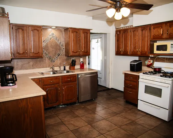 a kitchen with a sink appliances and cabinets