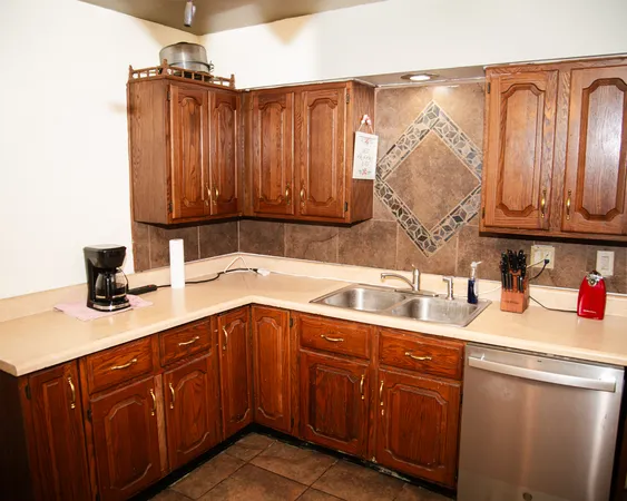 a kitchen with a sink cabinets and utility