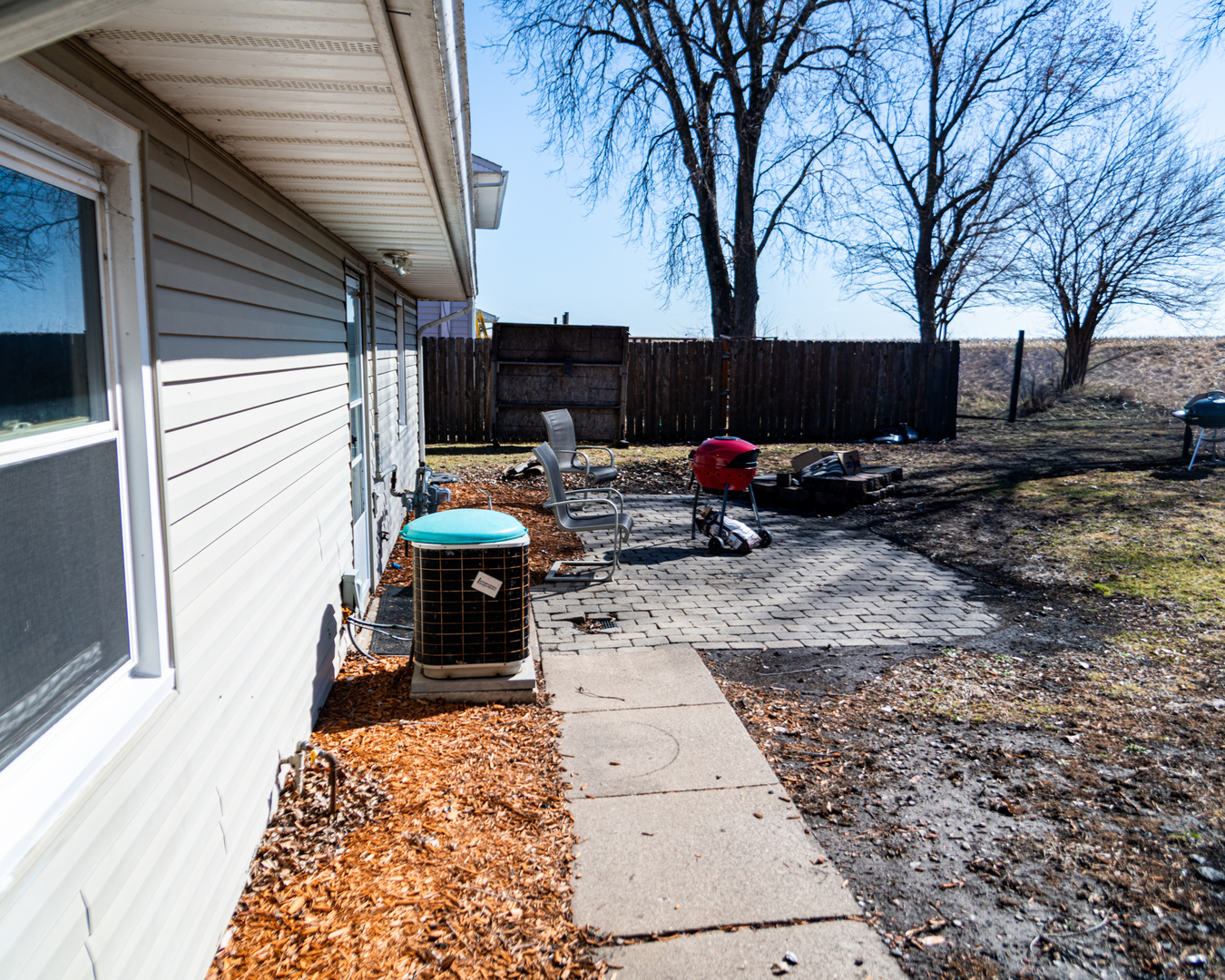 13610 137th Avenue West Taylor Ridge, IL 61284 - Photo 20 of 24 a backyard of a house with barbeque oven and outdoor seating