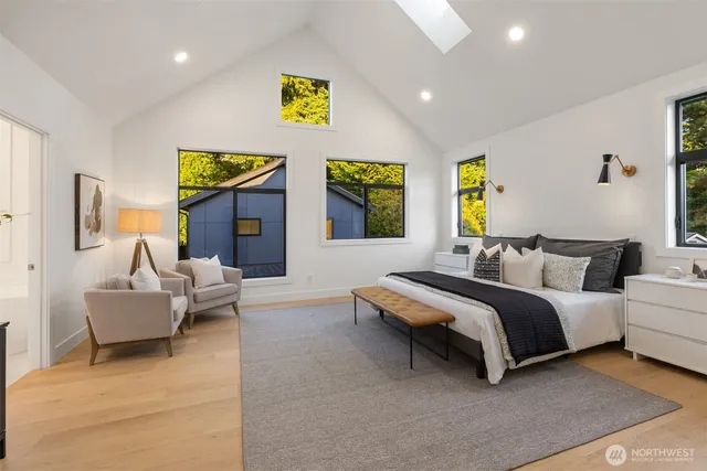 a spacious bedroom with a bed and couch