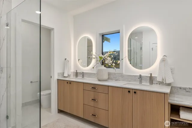 a bathroom with a double vanity sink and a mirror