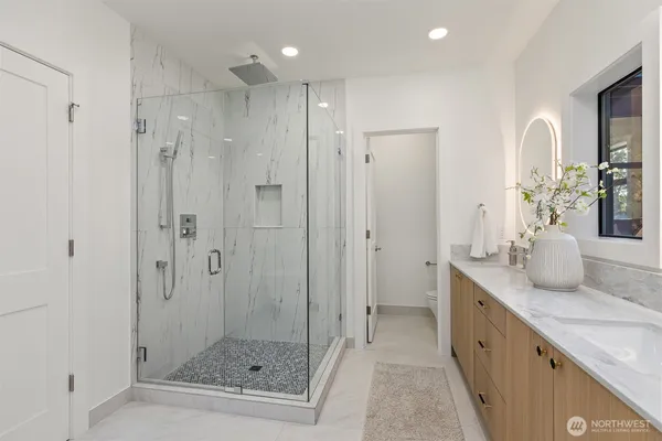 a bathroom with a granite countertop sink a mirror and a shower