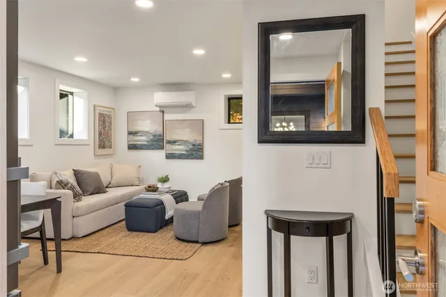 a living room with furniture and a potted plant