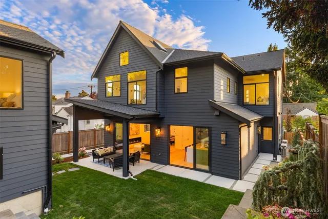 a view of a brick house with a large windows and a yard